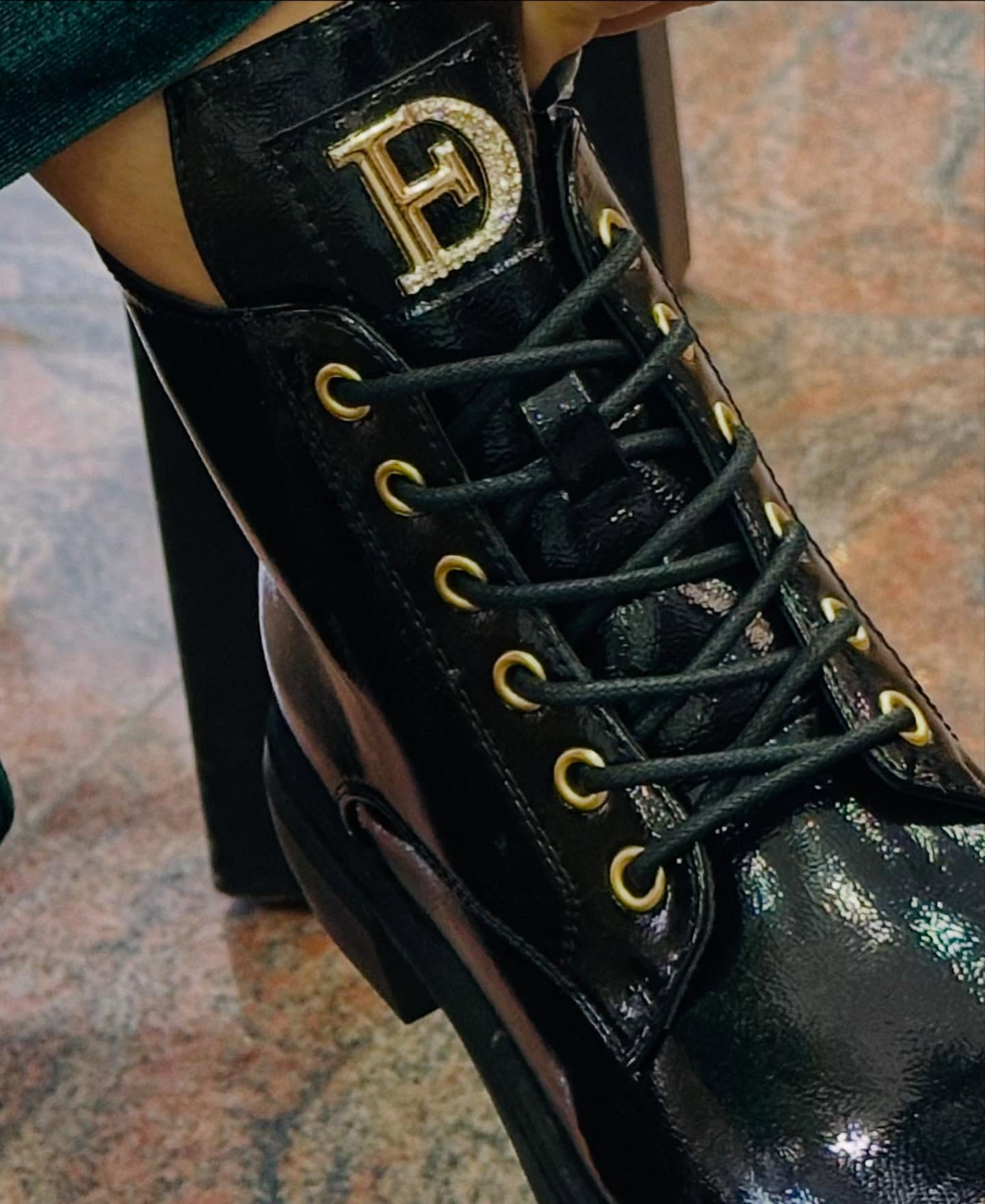 Military patent leather boot with appliqué.