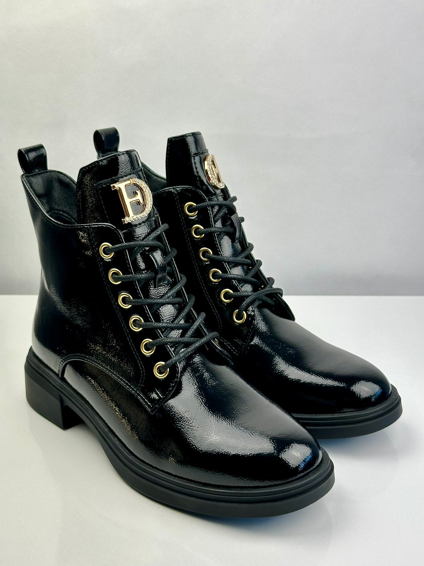 Military patent leather boot with appliqué.
