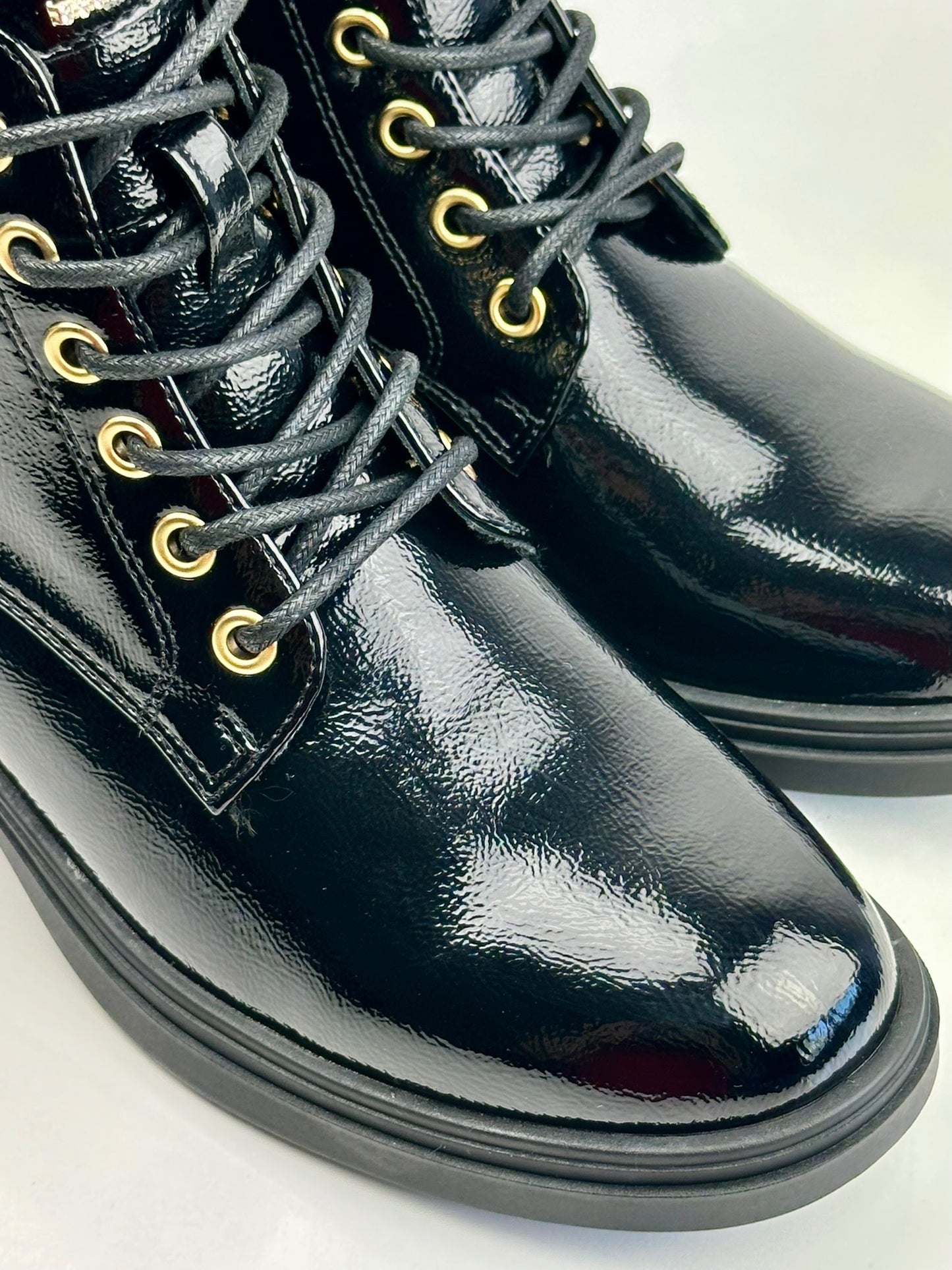 Military patent leather boot with appliqué.